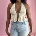 close up of a woman weraring white crochet top