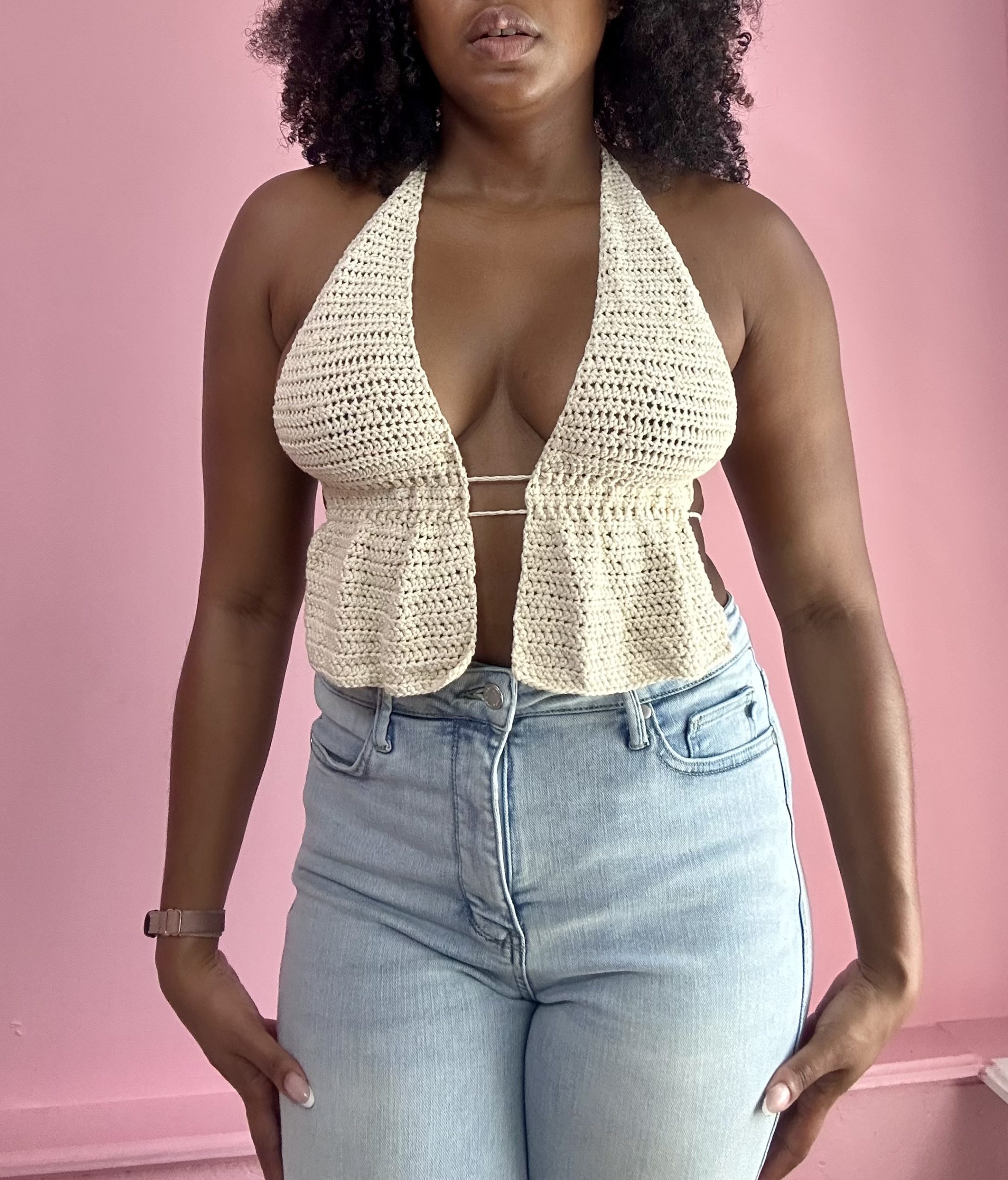 close up of a woman weraring white crochet top