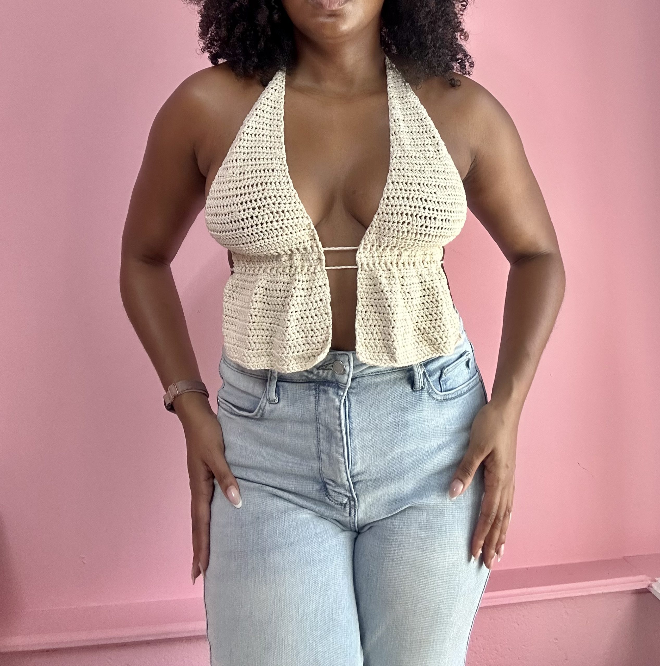 woman weraing white crochet top with ruffled hem