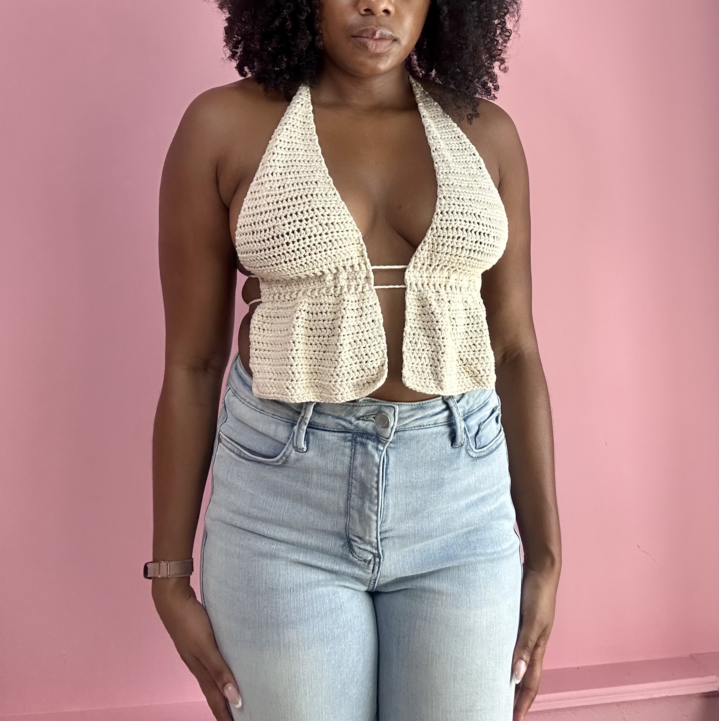 woman weraing white crochet top