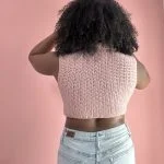 back of a woman wearing pink crochet top