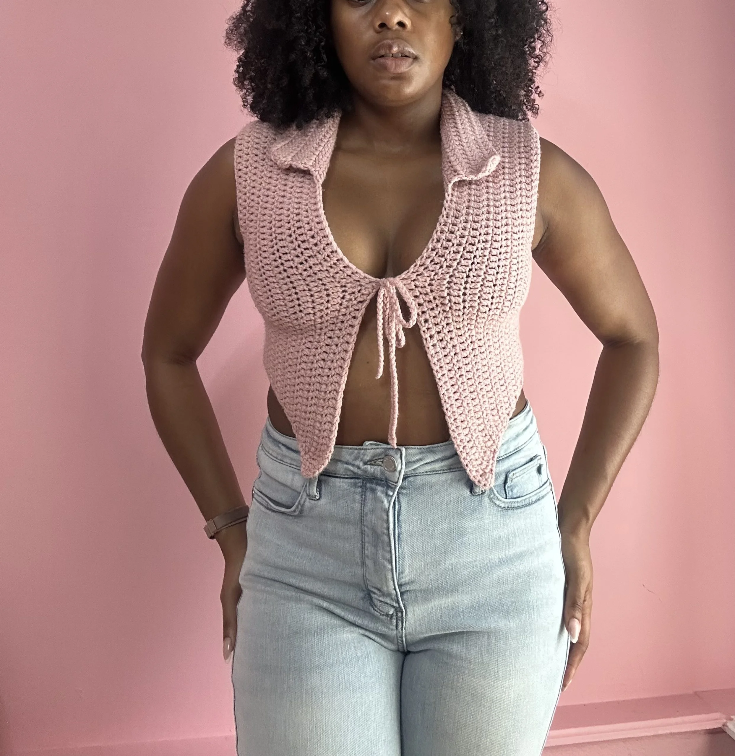 woman wearing pink crochet top with tie front