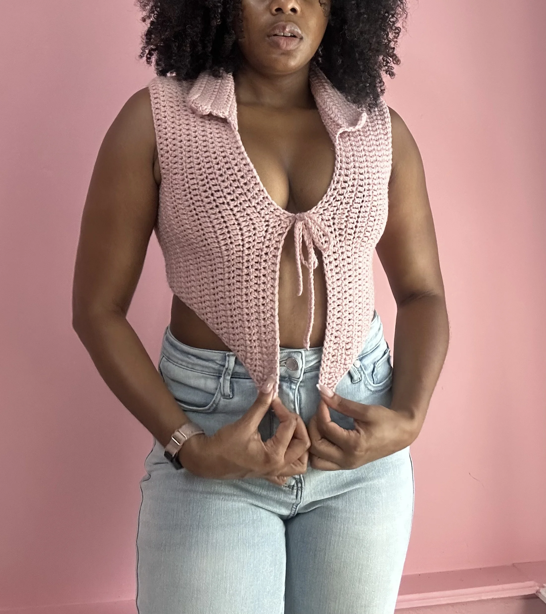 woman wearing pink crochet top with tie front