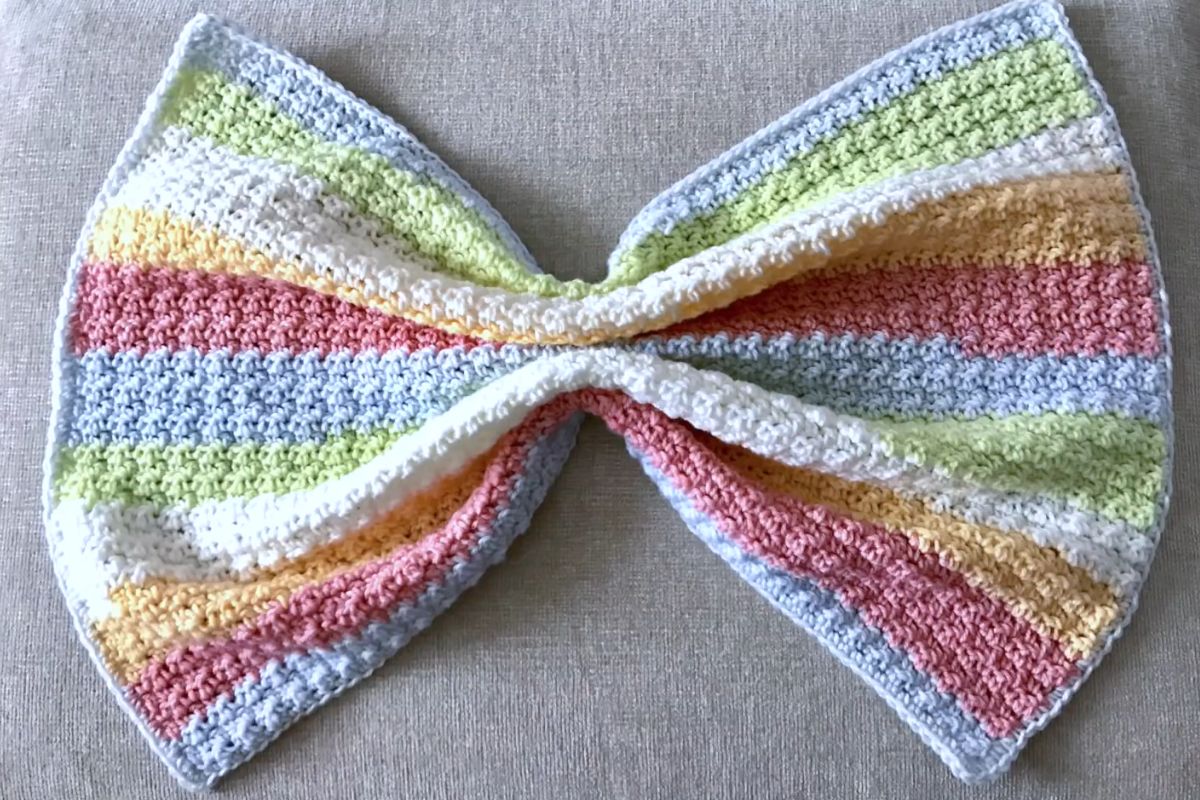 a simple crochet baby blanket with stripes in yellow, orange, pink and white