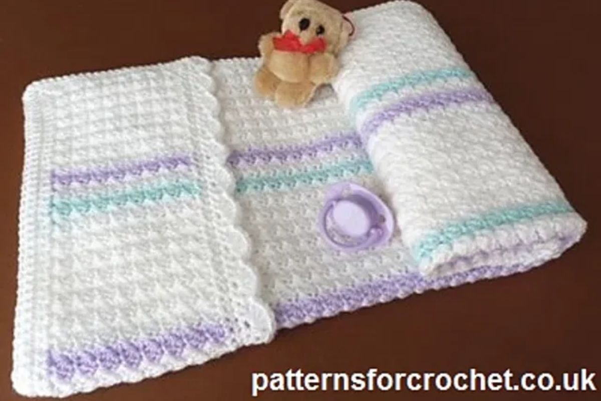 a delicate crochet baby blanket in light colors
