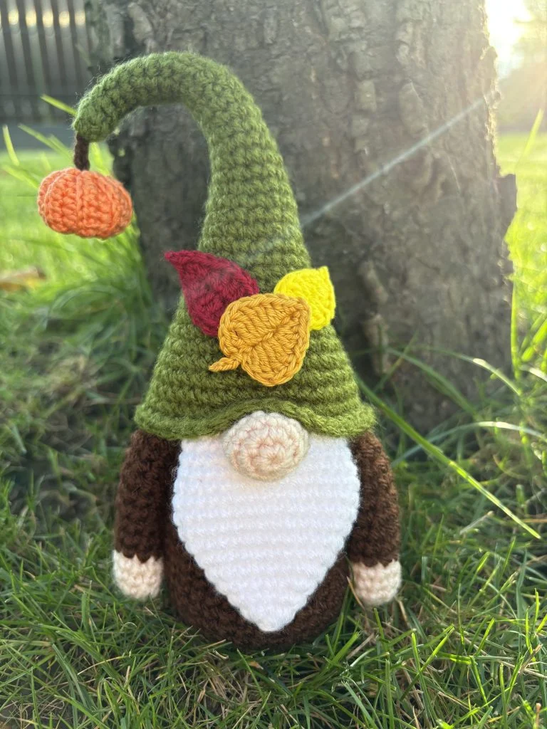 crochet gnome with autumnal hat with pumpkin and leaves