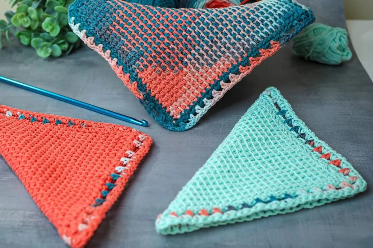 three crochet Tunisian potholders in different colors