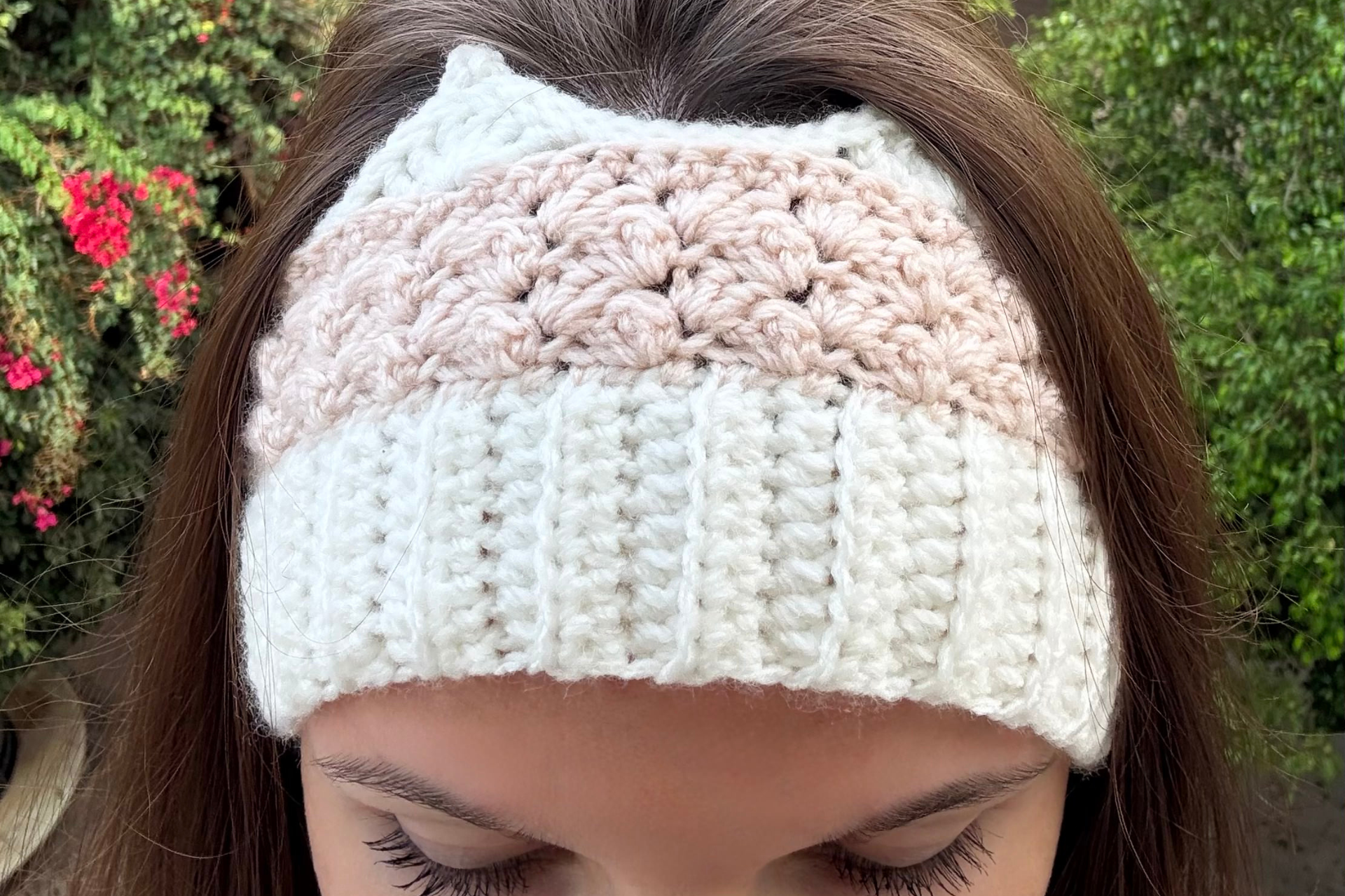 woman's head with white and dusty pink crochet crown headband