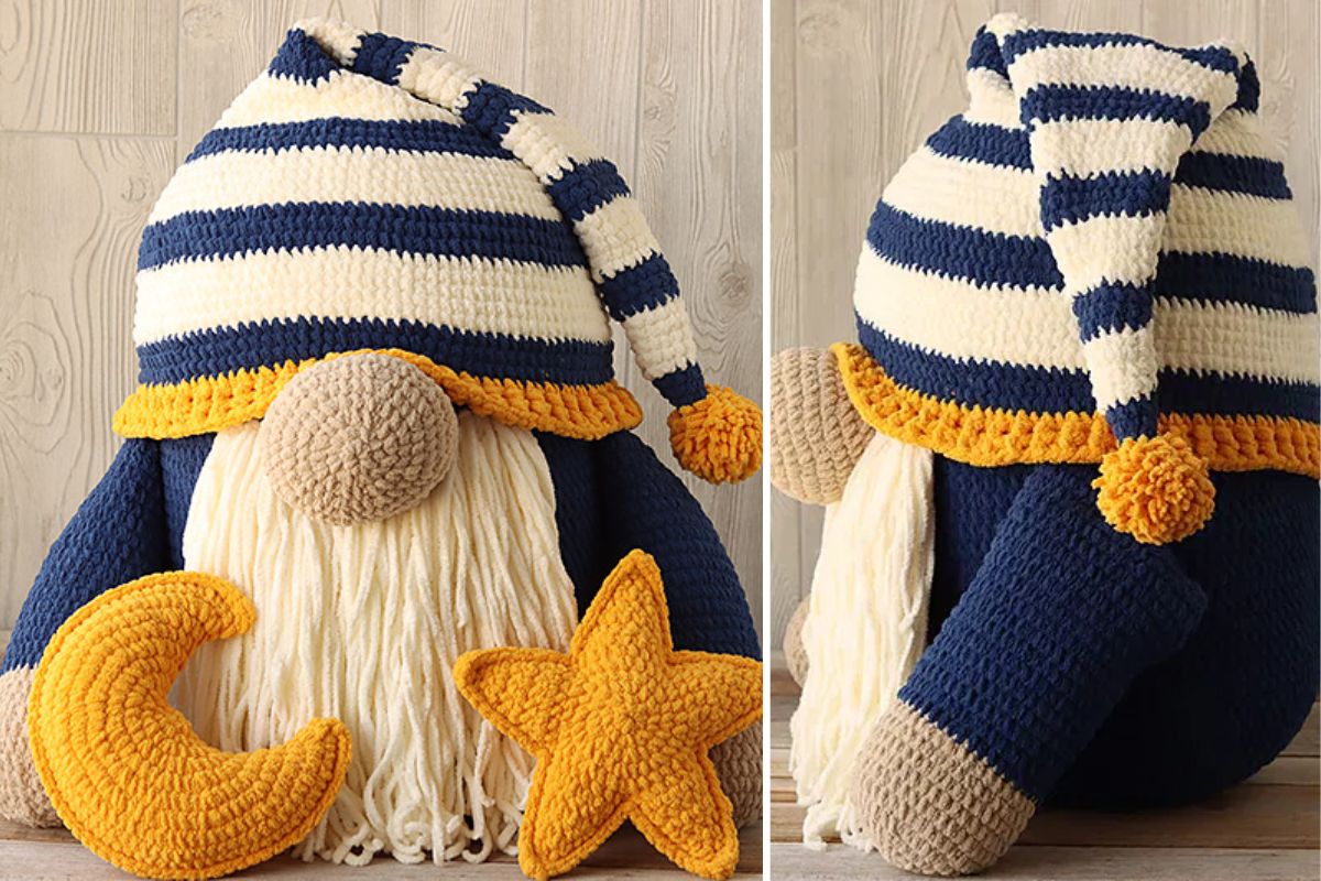 A Large Sleepy Time Gnome with Moon & Star Pillows features a crocheted gnome doll with a striped hat, white yarn beard, and yellow trim sitting beside plush crescent moon and star shapes on a wooden surface.