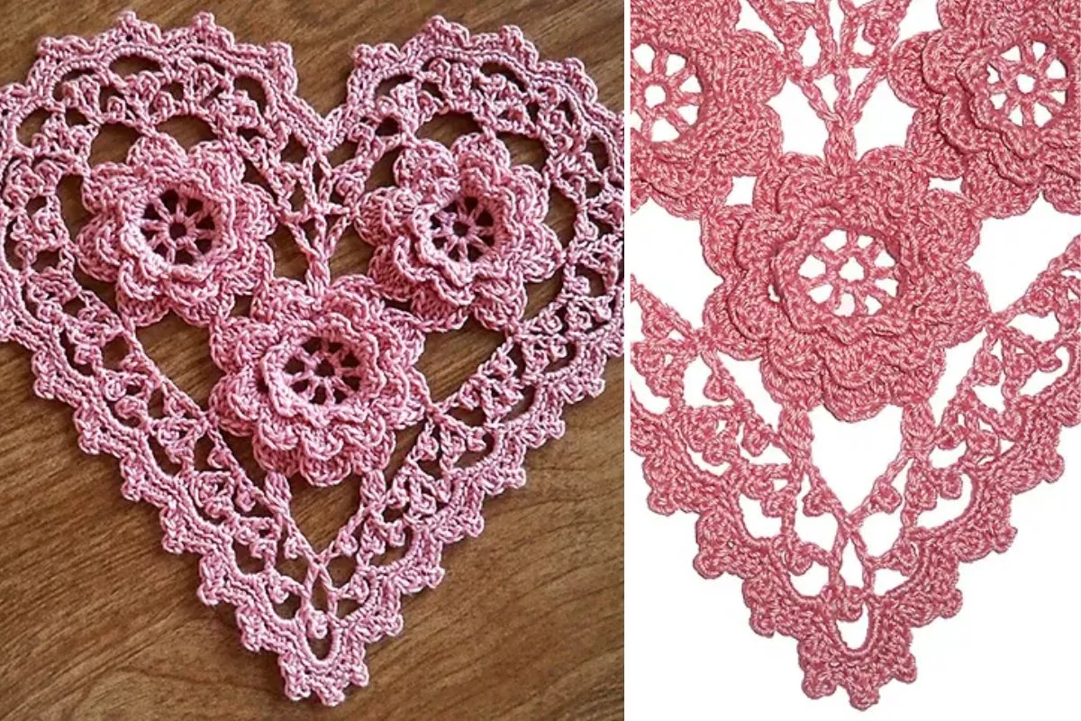 Pink crochet doily in the shape of a heart with floral patterns, displayed on a wooden surface and shown in close-up detail.
