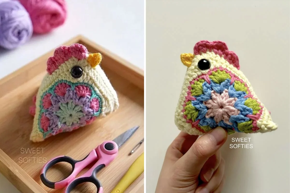 A crocheted chicken plush with colorful floral patterns, black button eyes, and a pink comb, shown on a wooden tray with scissors and yarn, and held in a hand.