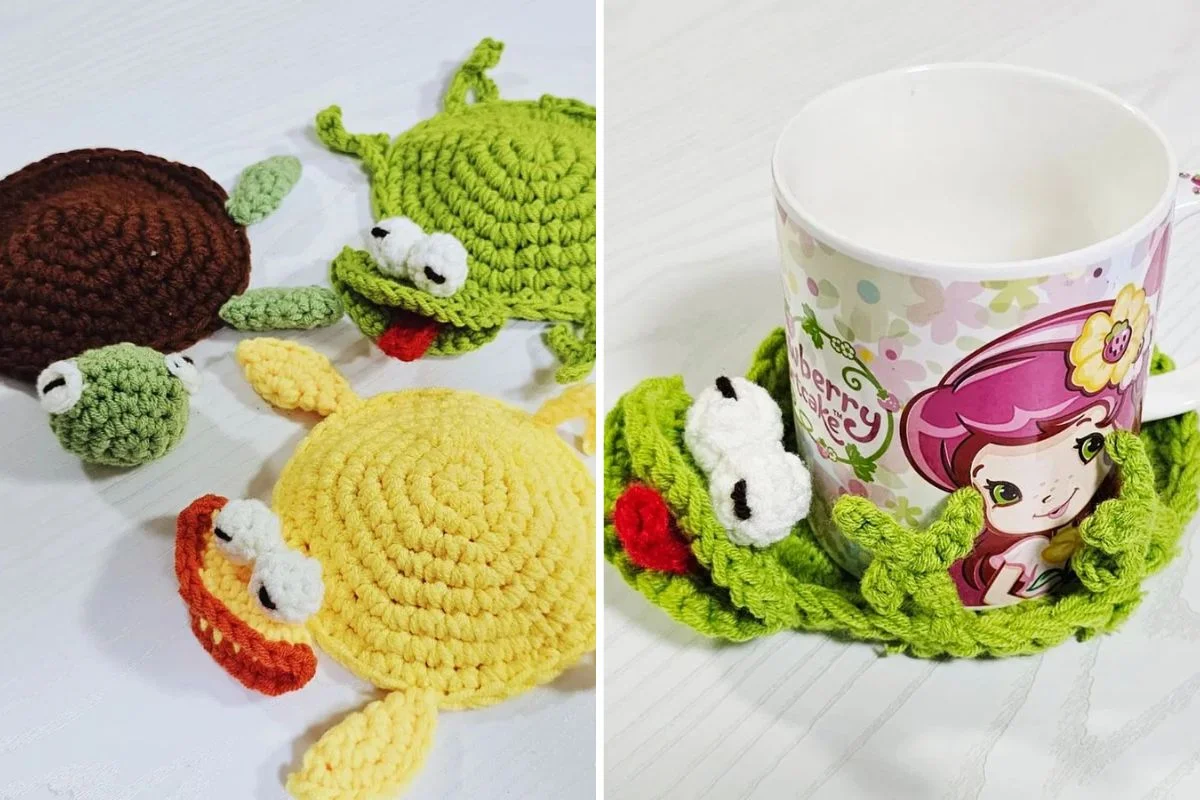 Two Pop-up Animal Coasters, one yellow and one brown, are shown next to a mug with a cartoon character, while a green crocheted coaster peeks out from underneath.
