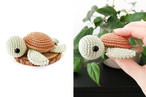 Crocheted turtle plush with a brown shell and green limbs, shown resting on a wooden surface and being held in a hand, with green plant leaves in the background—perfect beside your favorite Isobel Ear Warmer for cozy charm.