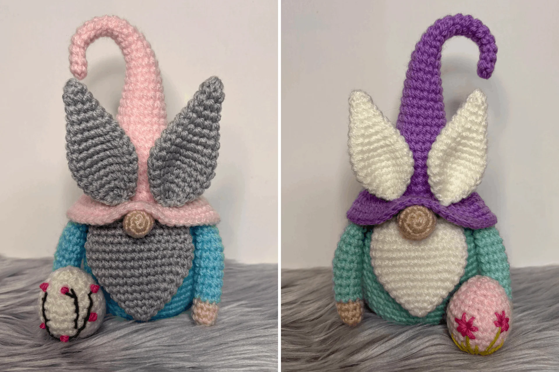 Two crocheted Easter gnomes with large hats and ears, each holding a small decorated egg, are displayed on a gray furry surface.