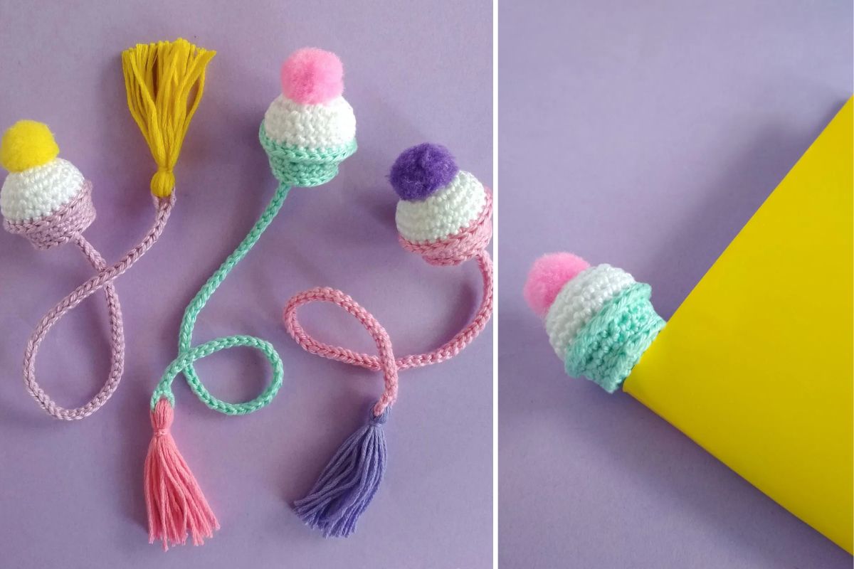 Three crocheted cupcake bookmarks with pom-pom tops and tassels in pastel colors are laid out on a purple surface; one is partially placed in a yellow envelope.