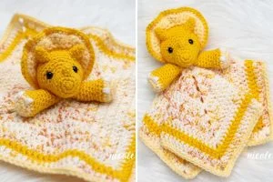 Crocheted yellow triceratops lovey plush attached to a matching yellow and cream baby blanket, shown on a white textured background.