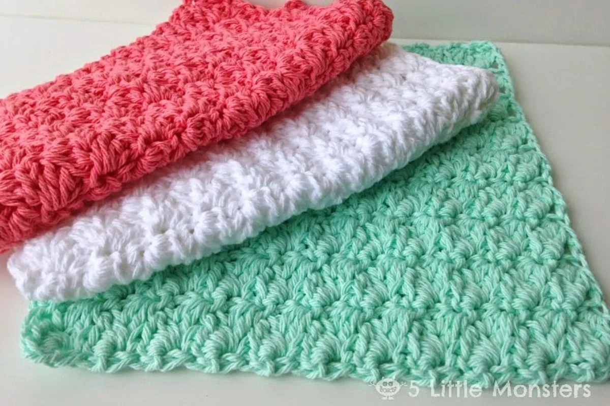 a set of crochet washcloths in green, white and red