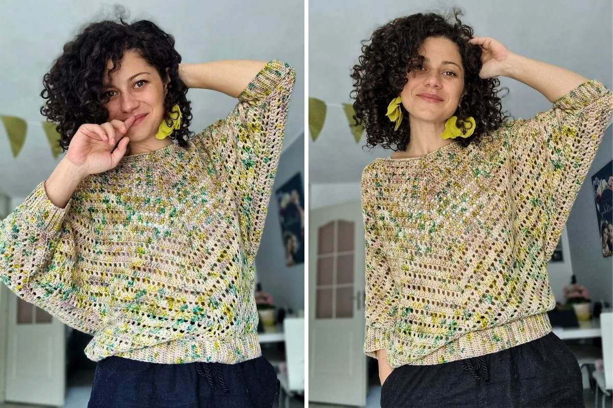 A woman with curly hair wears a loose, multicolored Starry Night Blouse and large yellow earrings, posing indoors in front of a white wall with decorations.