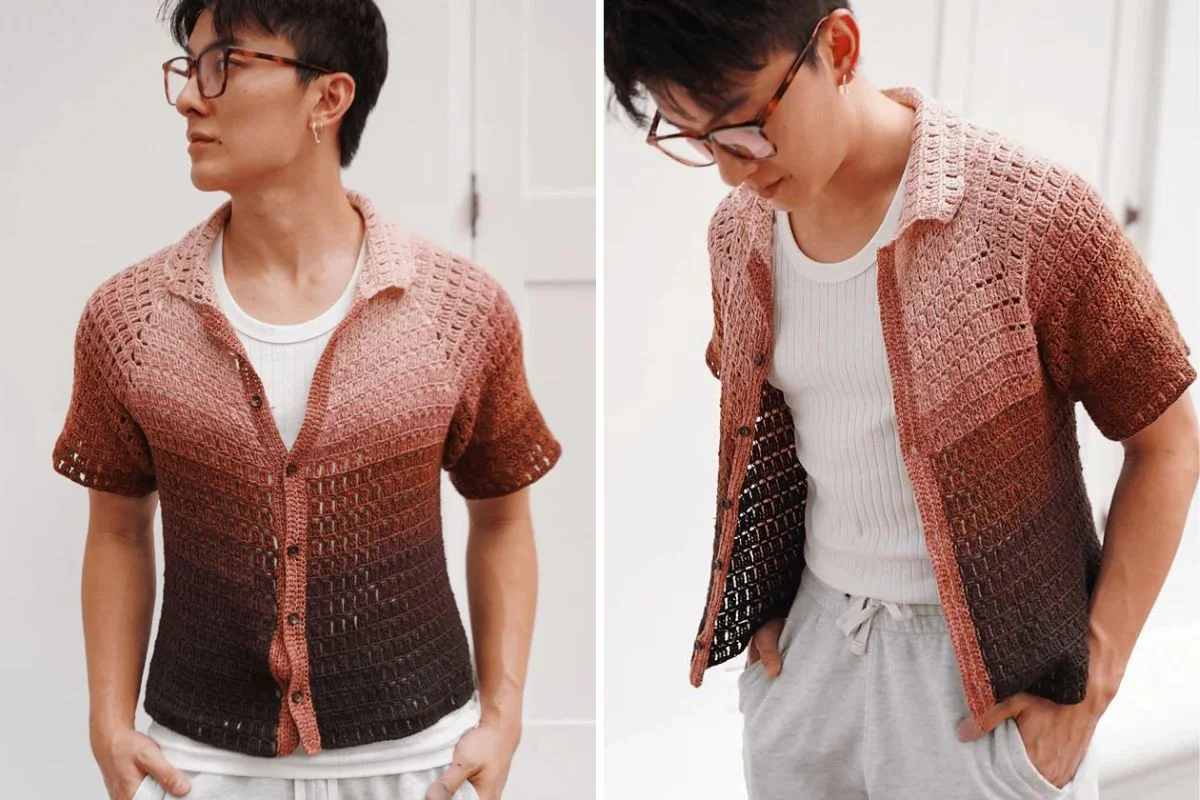 A man wearing glasses models a short-sleeve, button-up crochet shirt in shades of brown and pink over a white tank top.