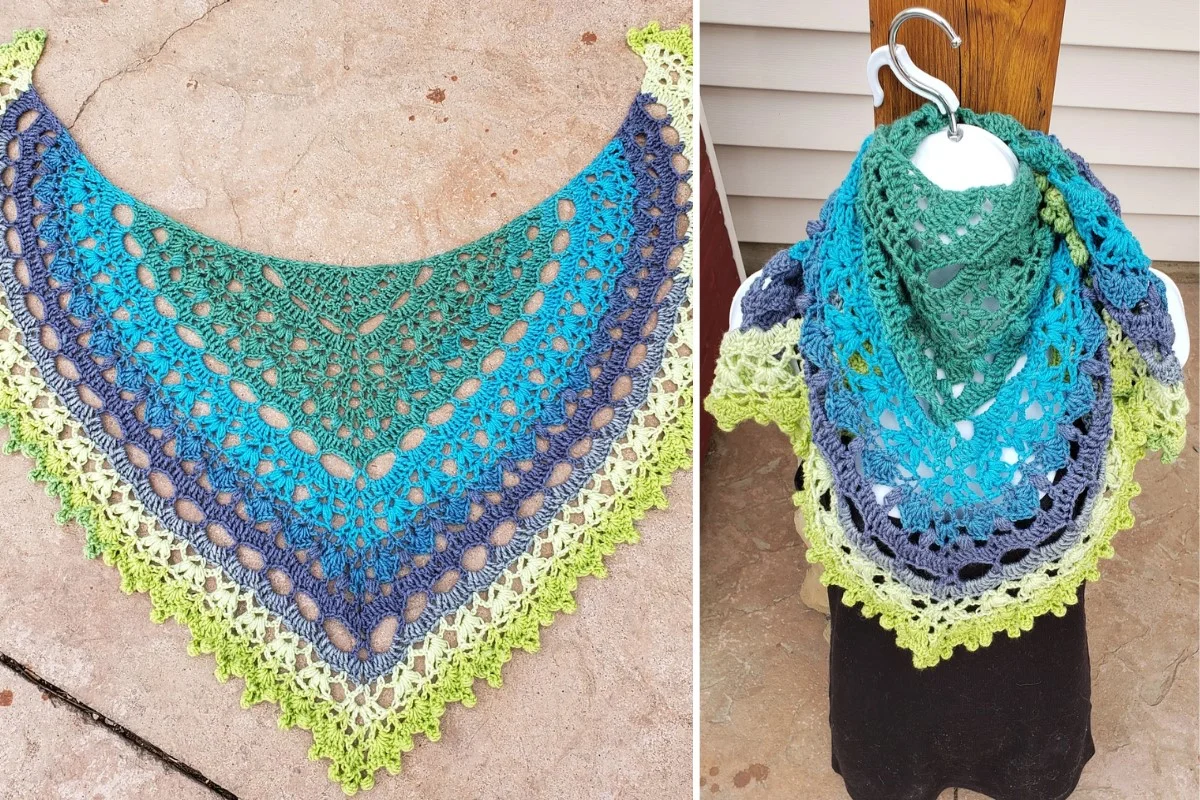 The Solitude Shawl, a triangular crocheted piece in green, blue, gray, and yellow tones, is shown flat on the left and draped elegantly on a mannequin to the right.