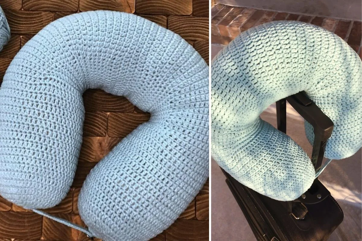 A light blue crocheted travel pillow is shown on a brown textured surface, wrapped around the handle of a suitcase.
