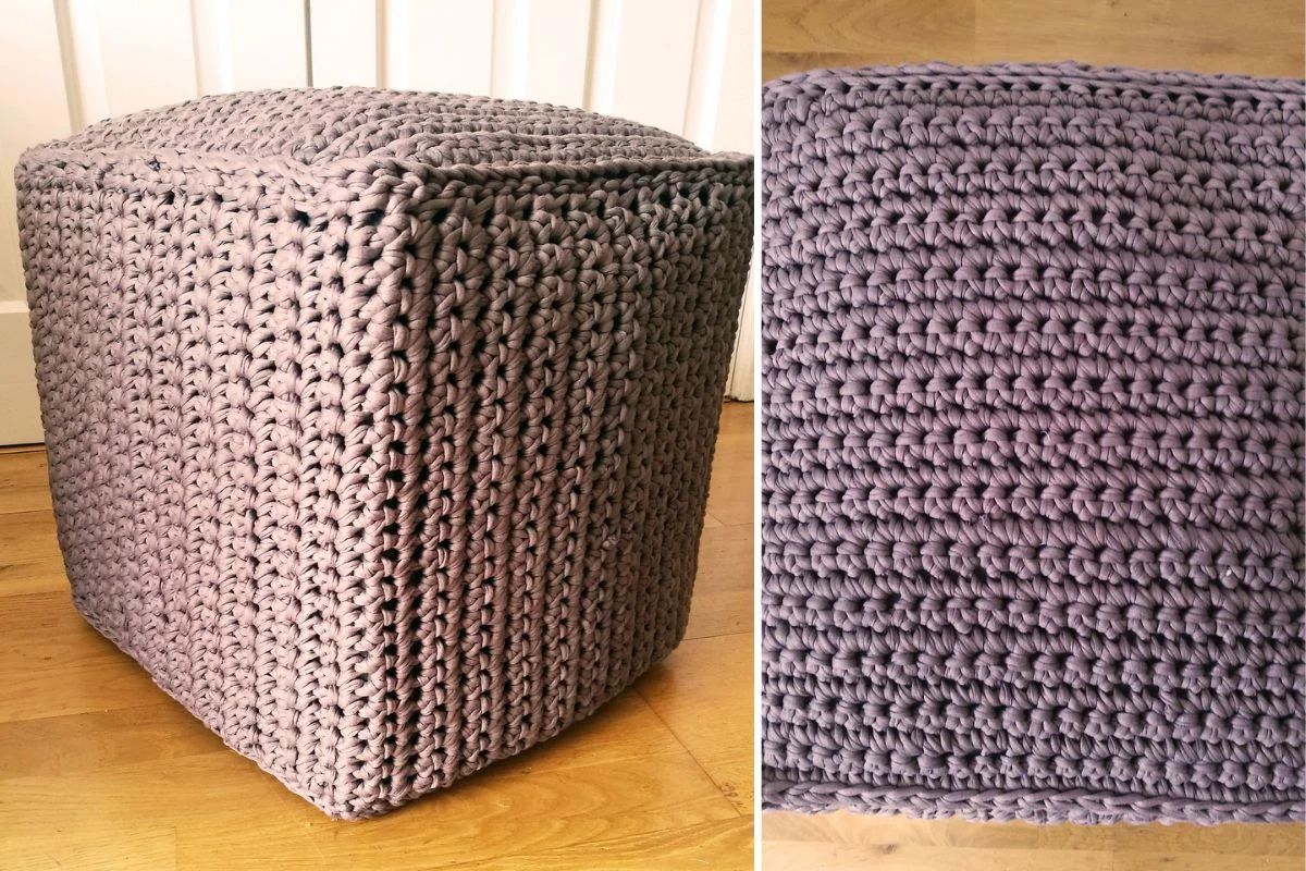 A chunky cube pouf ottoman with a thick, textured, lavender crochet cover is shown on a wooden floor, with a close-up view of the crochet pattern on the right.