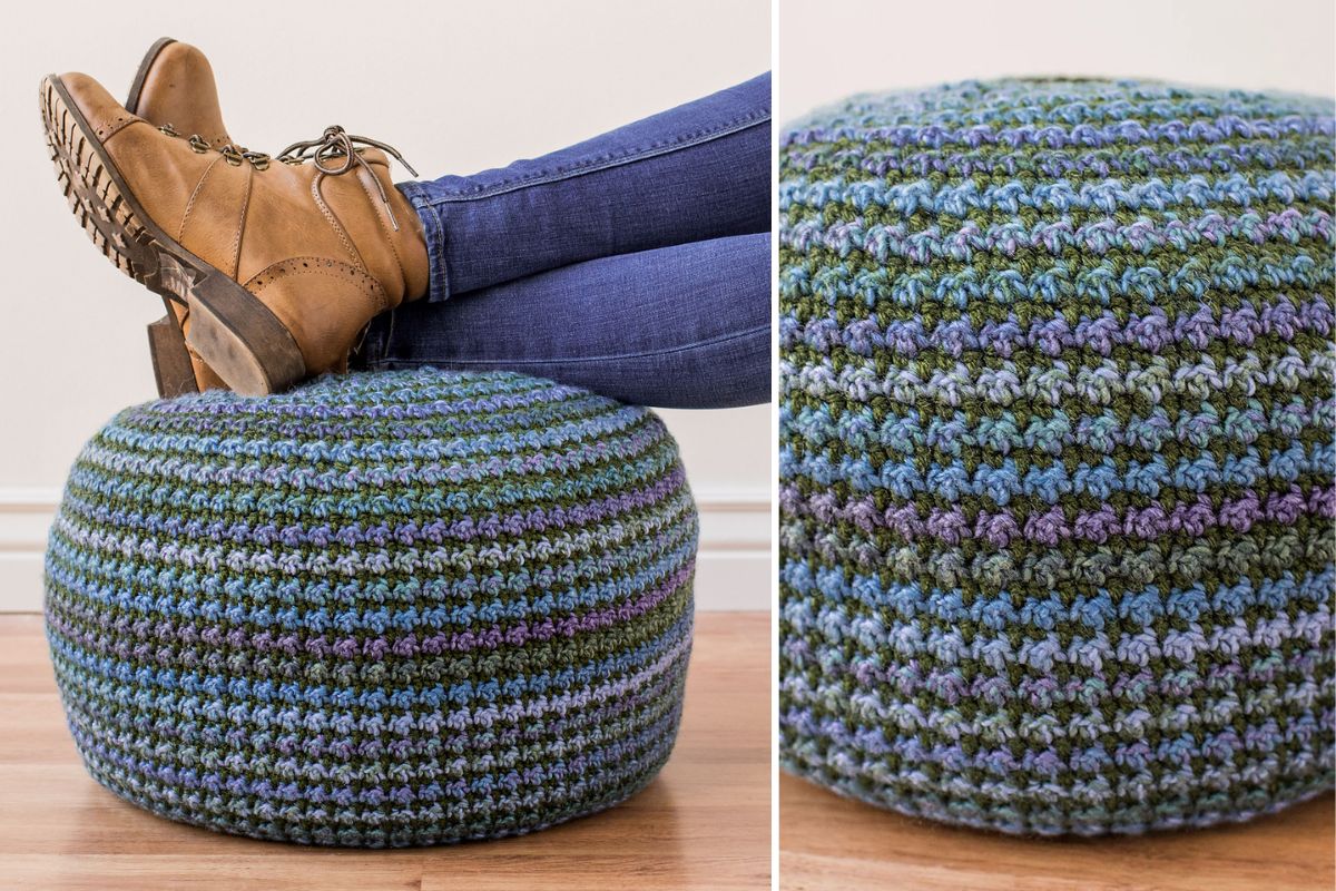 A person's legs rest on a round, crocheted footstool with blue, green, and purple stripes; close-up shows the textured crochet pattern.