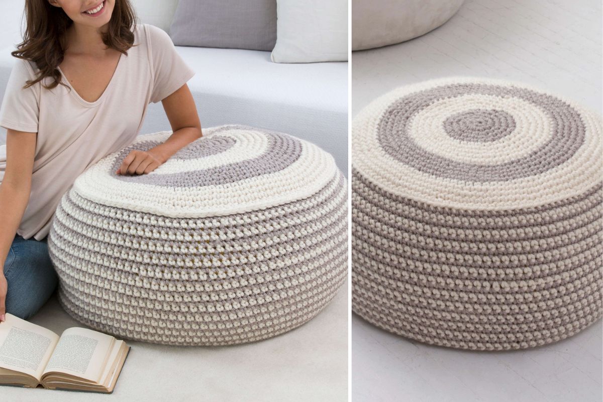 A person sits on the floor beside a stylish pouf—a round, knitted seat with white and gray stripes—while an open book lies nearby.