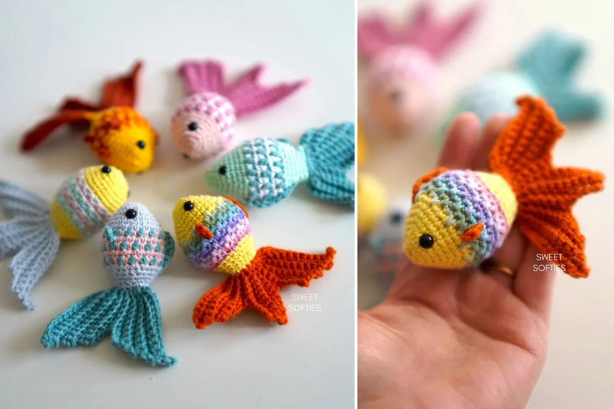 Several colorful crocheted fish, including a striking Mosaic Goldfish, are displayed on a surface, with one yellow, orange, and purple fish being held in a hand.