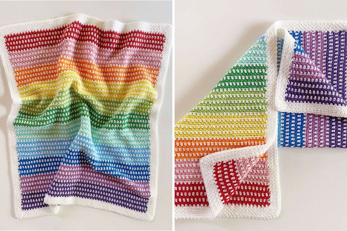 Two crocheted blankets featuring rainbow stripes and white borders are displayed, one folded and one spread out, on a white surface. Crafted with the Rainbow Moss Stitch Blanket technique, these cozy creations brighten any space with vibrant color and texture.