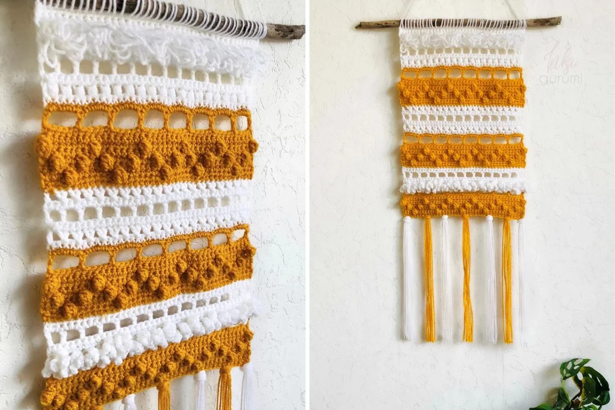 A handmade Boho wallhanging featuring alternating white and mustard yellow crochet patterns, suspended from a branch, with long yellow and white yarn fringes cascading at the bottom.