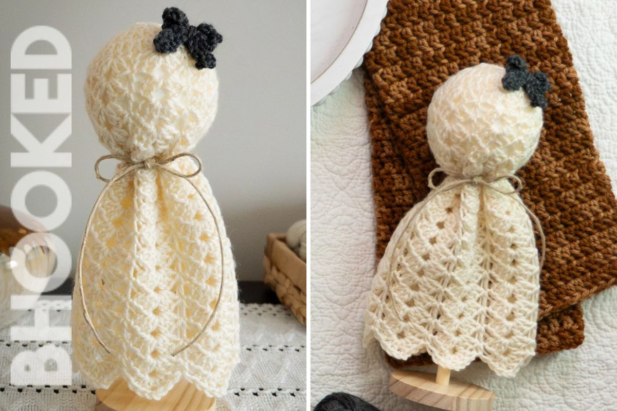 A crocheted angel with a lacy cream dress and a small dark bow on its head is displayed standing on a wooden base.