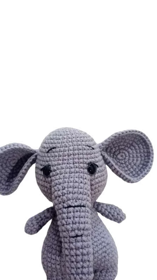 A grey crocheted elephant toy crafted with the same attention to detail as a crochet pumpkin pattern.