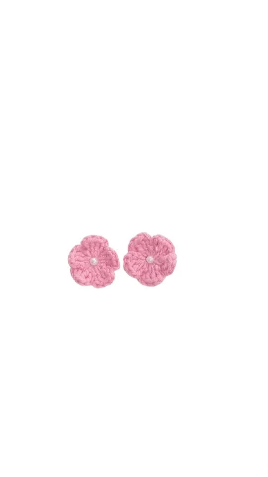 Pair of light pink crochet flower earrings with small white pearls at the center, crafted with the same delicate detail as an elephant amigurumi.