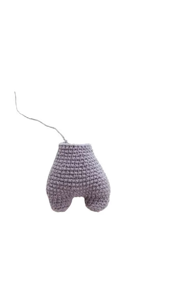 Crocheted lavender elephant amigurumi in the shape of two legs joined at the torso, with a trailing yarn tail.