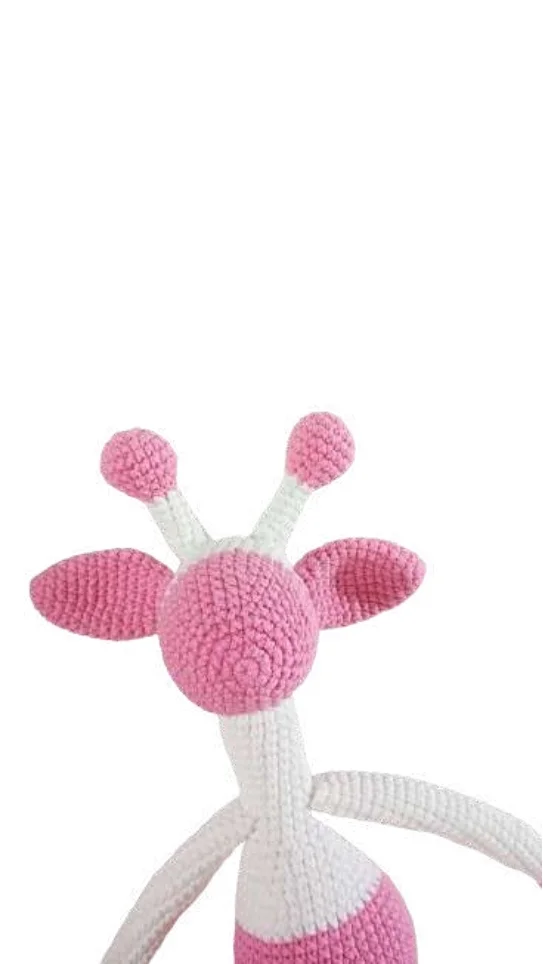 A crochet giraffe amigurumi with a pink head, white neck, and pink-tipped horns.