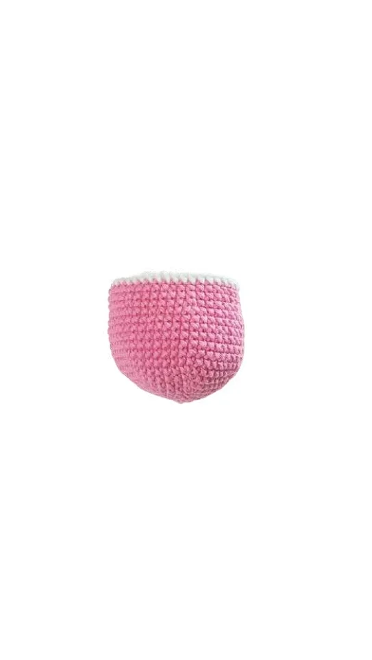 Small pink crocheted basket with a white rim, crafted in the style of a pumpkin crochet pattern.