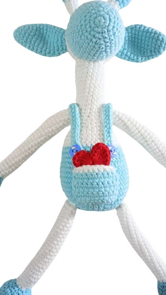Crocheted giraffe amigurumi with a long white neck, light blue overalls, and a small red heart in the pocket.