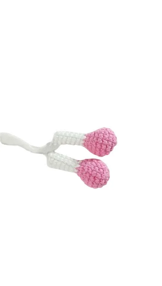 Two crocheted pink and white stems resembling matchsticks joined at the base, styled like those found in a giraffe amigurumi.