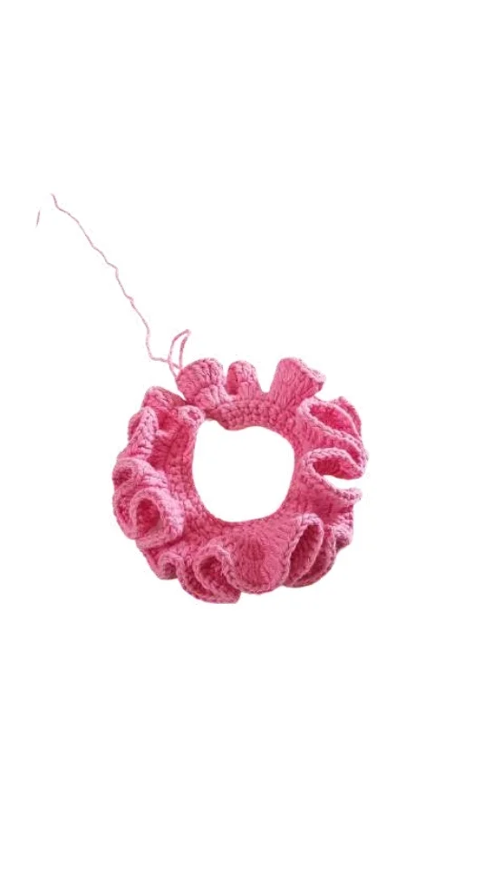 Pink crocheted ruffle scrunchie, perfect for those who enjoy a crochet pumpkin pattern style.