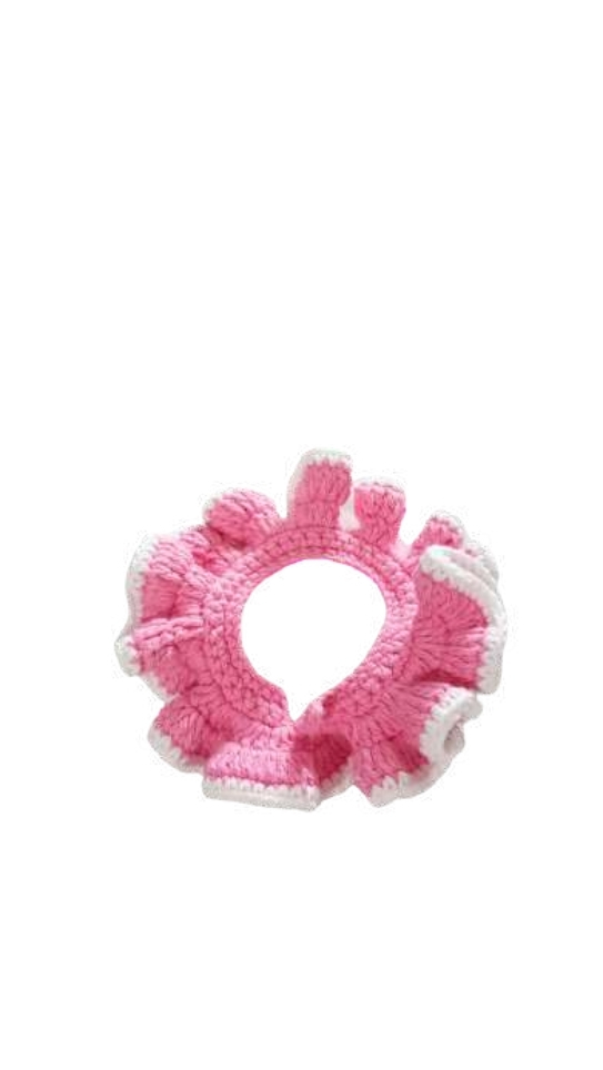 A crocheted pink and white ruffled collar for a pet, styled like a decorative pumpkin crochet pattern accessory.