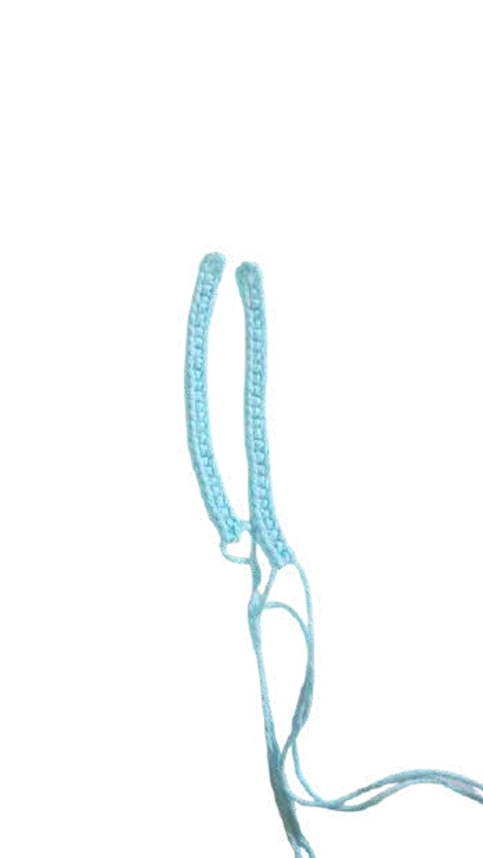 Two light blue crocheted strips with loose yarn tails, featured in a free crochet pumpkin pattern.