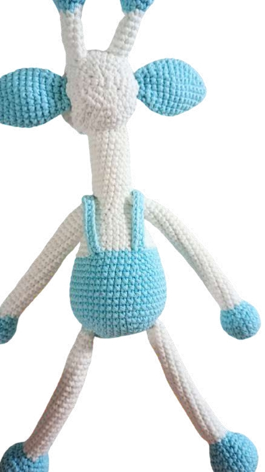 Crochet giraffe amigurumi in white and light blue, wearing blue overalls.