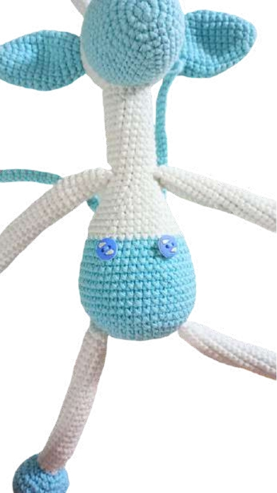 Crocheted giraffe amigurumi with a white and blue head and body, featuring two blue buttons on its midsection.